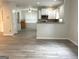 Open-concept living area with modern flooring and a view into the kitchen at 3700 Newhalem Sw St, Atlanta, GA 30331