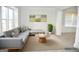 Bright living room featuring neutral decor, a sectional couch, and a columned archway at 3700 Newhalem Sw St, Atlanta, GA 30331