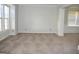 Living room featuring windows and carpet flooring, with an open space concept at 3700 Newhalem Sw St, Atlanta, GA 30331