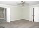 Spacious main bedroom featuring durable carpet floors, ceiling fan, and ensuite bathroom at 3700 Newhalem Sw St, Atlanta, GA 30331