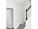 Staircase with carpeted steps and white railing, complemented by neutral wall paint at 3700 Newhalem Sw St, Atlanta, GA 30331