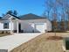 New construction home featuring a two-car garage and well-maintained landscaping at 139 Oakchase Park Ln, Hampton, GA 30228
