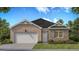 Charming one-story brick home featuring a two-car garage and manicured lawn at 139 Oakchase Park Ln, Hampton, GA 30228