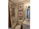 Bathroom with shower-tub combo, white vanity, floral art, and modern fixtures at 10178 Top Tree Ct, Jonesboro, GA 30238