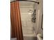 Bright bathroom with a shower-tub combo, modern fixtures, and storage at 10178 Top Tree Ct, Jonesboro, GA 30238