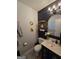 Stylish powder room featuring black and white accents, decorative mirrors and a vanity sink at 10178 Top Tree Ct, Jonesboro, GA 30238