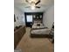 Bedroom features a black accent wall, soft carpet, fan, and natural light at 10178 Top Tree Ct, Jonesboro, GA 30238
