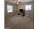 Spacious bedroom with neutral carpet, dual windows, and a dark desk with shelving at 10178 Top Tree Ct, Jonesboro, GA 30238