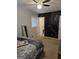 Bedroom showcases modern black accent wall with gold design, soft carpet, and fan at 10178 Top Tree Ct, Jonesboro, GA 30238