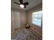 Bedroom with neutral walls, ceiling fan, window, and a gray patterned rug at 10178 Top Tree Ct, Jonesboro, GA 30238