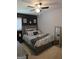 Nicely decorated bedroom featuring a queen-sized bed, black accent wall, and modern décor at 10178 Top Tree Ct, Jonesboro, GA 30238