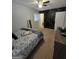 Bedroom showcases modern black accent wall with gold design, soft carpet, and fan at 10178 Top Tree Ct, Jonesboro, GA 30238