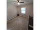 Neutral bedroom featuring a ceiling fan, window and brown carpet at 10178 Top Tree Ct, Jonesboro, GA 30238