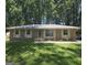 Charming brick home with a well-manicured lawn and mature trees at 10178 Top Tree Ct, Jonesboro, GA 30238