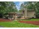 This home has a lovely backyard with a dining area, grill, and mature trees at 4080 Derby Dr, Cumming, GA 30040