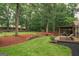 Beautiful backyard featuring a wooden deck, pergola, and a lush lawn with mature trees at 4080 Derby Dr, Cumming, GA 30040