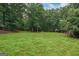 The home features a spacious backyard with mature trees offering ample privacy at 4080 Derby Dr, Cumming, GA 30040