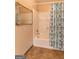 Bathroom featuring a bathtub with a shower with tan tile flooring at 4080 Derby Dr, Cumming, GA 30040