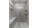Modern bathroom featuring a glass-enclosed shower with stylish tile, built-in shelves and tiled shower seating at 4080 Derby Dr, Cumming, GA 30040