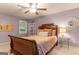Bedroom with dark wood sleigh bed and decorative shelving at 4080 Derby Dr, Cumming, GA 30040