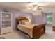 Bedroom with dark wood sleigh bed and decorative shelving at 4080 Derby Dr, Cumming, GA 30040