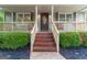 Charming front porch with brick steps, decorative railing, and a stained glass front door at 4080 Derby Dr, Cumming, GA 30040