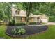 Charming two-story home featuring a cozy front porch, manicured landscaping, and an attached two car garage at 4080 Derby Dr, Cumming, GA 30040