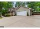 Lovely two-story home featuring a two-car garage and a long driveway surrounded by mature trees at 4080 Derby Dr, Cumming, GA 30040