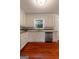 Bright kitchen featuring white cabinets, granite countertops, stainless steel appliances, and hardwood floors at 4080 Derby Dr, Cumming, GA 30040