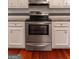 Well-equipped kitchen featuring stainless steel oven/stove and white cabinetry and stainless steel appliances at 4080 Derby Dr, Cumming, GA 30040