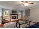 Cozy living room with a fireplace, hardwood floors, and comfortable seating at 4080 Derby Dr, Cumming, GA 30040