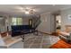 Comfortable living room featuring hardwood floors, plush gray rug, and a stylish navy blue couch at 4080 Derby Dr, Cumming, GA 30040