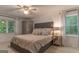 Relaxing bedroom featuring a comfortable bed, natural light, and ceiling fan and large windows overlooking nature at 4080 Derby Dr, Cumming, GA 30040