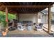 Covered outdoor living space with a built-in grill and dining area at 4080 Derby Dr, Cumming, GA 30040