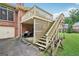 Backyard with wooden staircase leading to the second-story deck and brick siding at 1214 Lambeth Se Way, Conyers, GA 30013