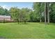 Expansive grassy backyard, partially fenced, providing ample space for outdoor activities at 1214 Lambeth Se Way, Conyers, GA 30013
