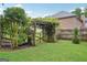 Landscaped backyard featuring a covered wooden gate providing a secluded outdoor area at 1214 Lambeth Se Way, Conyers, GA 30013