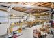 Unfinished basement space with exposed ceiling, workbench, and storage shelves for potential workshop or hobby area at 1214 Lambeth Se Way, Conyers, GA 30013