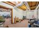 Unfinished basement with exposed ceiling beams, carpet, and clutter at 1214 Lambeth Se Way, Conyers, GA 30013