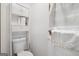 A toilet with a linen closet featuring white paint, shelves and drawers at 1214 Lambeth Se Way, Conyers, GA 30013