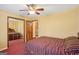 Bedroom with a ceiling fan, a bed with striped bedding, and closet doors with mirrors at 1214 Lambeth Se Way, Conyers, GA 30013