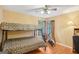Bedroom with bunk beds, a ceiling fan, and an exercise bike next to a window at 1214 Lambeth Se Way, Conyers, GA 30013