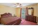 Bedroom featuring wood dresser, plush carpet, natural light, and a ceiling fan at 1214 Lambeth Se Way, Conyers, GA 30013