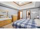 Bedroom featuring wooden dressers, carpeted floors, and double tray ceiling at 1214 Lambeth Se Way, Conyers, GA 30013