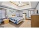 Comfortable bedroom with carpeted floor, ceiling fan, and double tray ceiling at 1214 Lambeth Se Way, Conyers, GA 30013