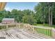 Spacious wooden deck with stairs offering a view of the house and lush greenery at 1214 Lambeth Se Way, Conyers, GA 30013