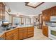 Spacious kitchen featuring wood cabinets, tile floor, cooktop, and a connecting breakfast nook with lots of light at 1214 Lambeth Se Way, Conyers, GA 30013