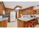 Spacious kitchen featuring wooden cabinets, tile floors and breakfast bar at 1214 Lambeth Se Way, Conyers, GA 30013