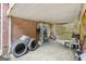 Covered patio with brick wall, offering a sheltered outdoor space for storage or relaxation at 1214 Lambeth Se Way, Conyers, GA 30013