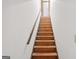 Wooden staircase leading upwards with white walls and handrail at 1214 Lambeth Se Way, Conyers, GA 30013